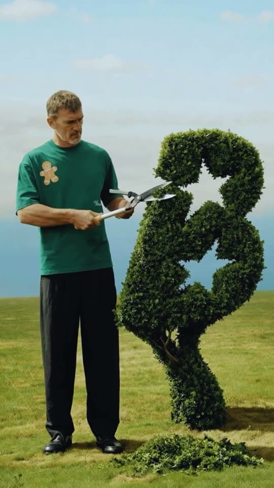 A gardener trimming a hedge into the Bunsy bunny